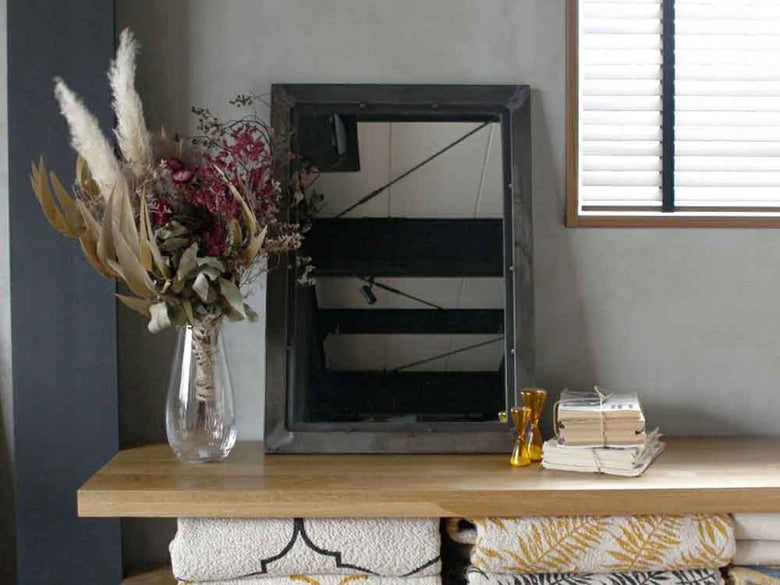 リビングに飾られたadepecheのスチールミラーと植物