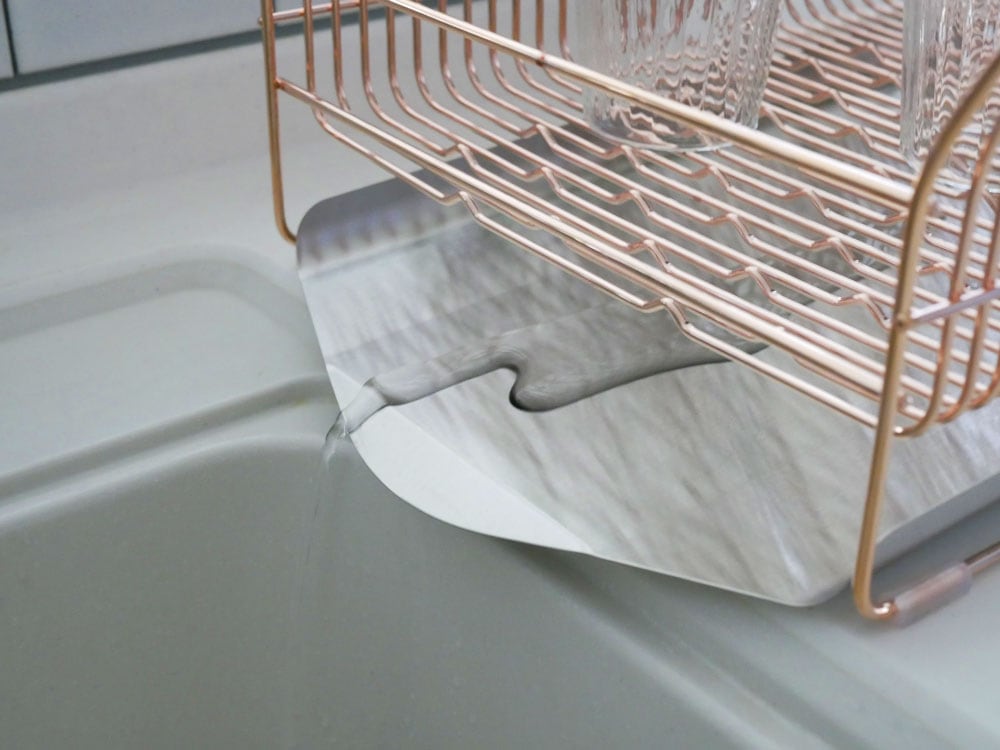 hanautaブランドの横置きステンレス製水切りラック。ローズゴールドメッキの箸立てとトレイが特徴的で、キッチンカウンター上に設置されています。