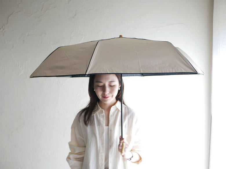 ビコーズの遮光率100%晴雨兼用傘を持つモデル