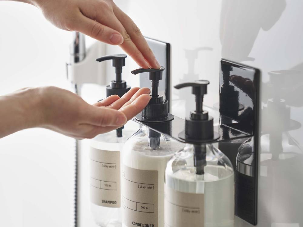 スチール製マグネットディスペンサーホルダーと石鹸ボトルが配置された洗面台