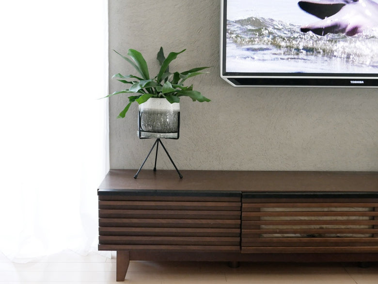 リビングの木床に置かれたポッシュリビングのアイアン製トライポッドスタンド