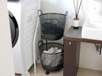 銀色の2段ランドリーバスケットと洗濯機