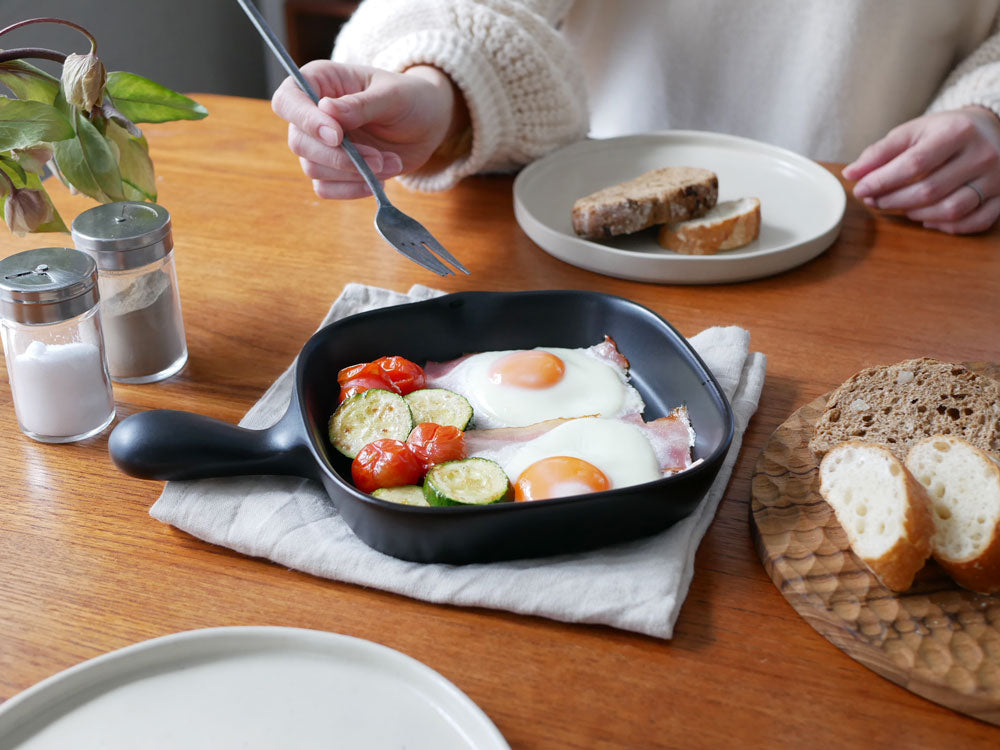 トウジキトンヤの萬古焼グリルプレート上で目玉焼きを調理している様子とキッチン用品