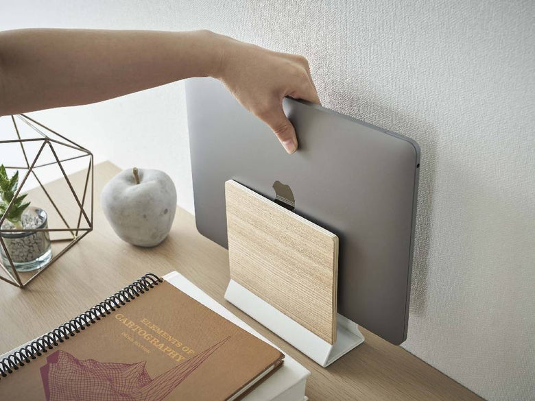 RIN/リンのスリムノートパソコンスタンドが天然木とスチールでデスク上に設置され、ノートパソコンを安定して支えている様子