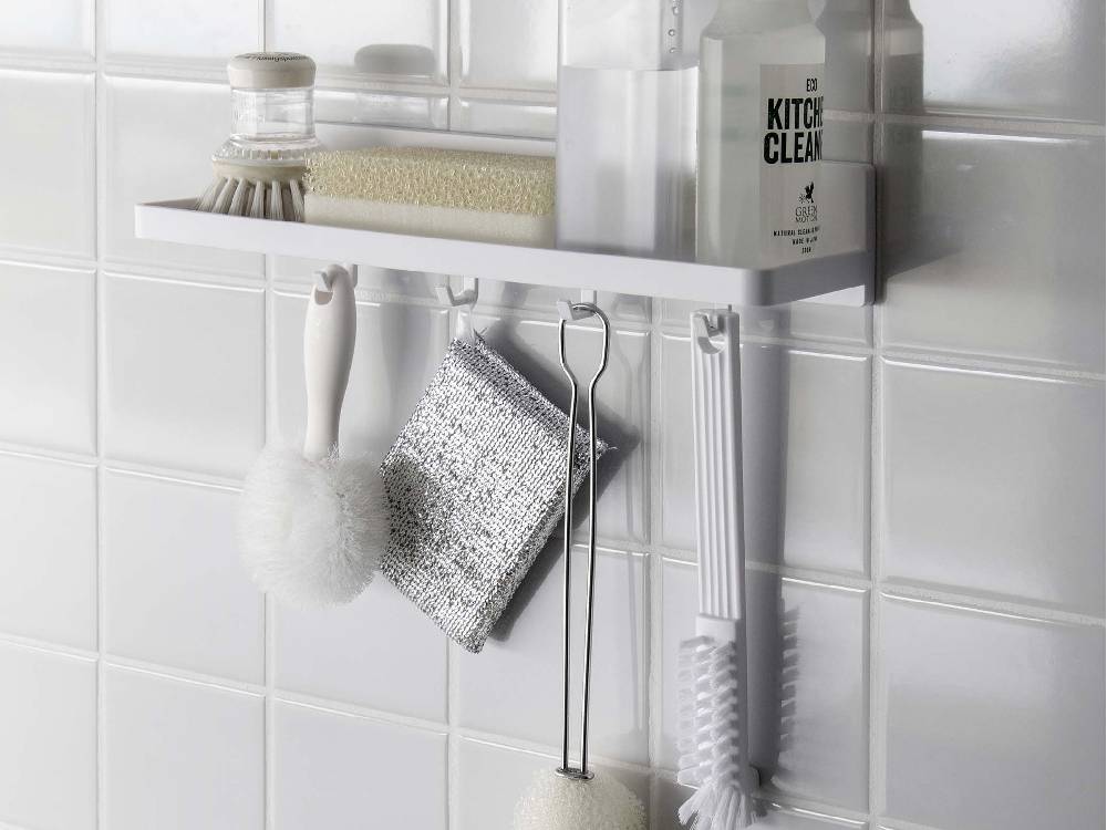 MISTミストフィルムフック トレー W30がキッチンの棚に取り付けられ、ボトルやブラシなどの家庭用品が整然と整理されている様子