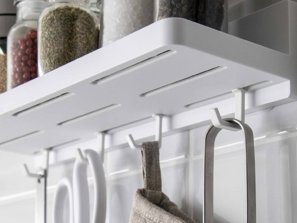 キッチンの棚に取り付けられた【MIST/ミスト】フィルムフック トレー W30。ステンレス製の収納棚に調理器具や家庭用品が整然と配置されています。