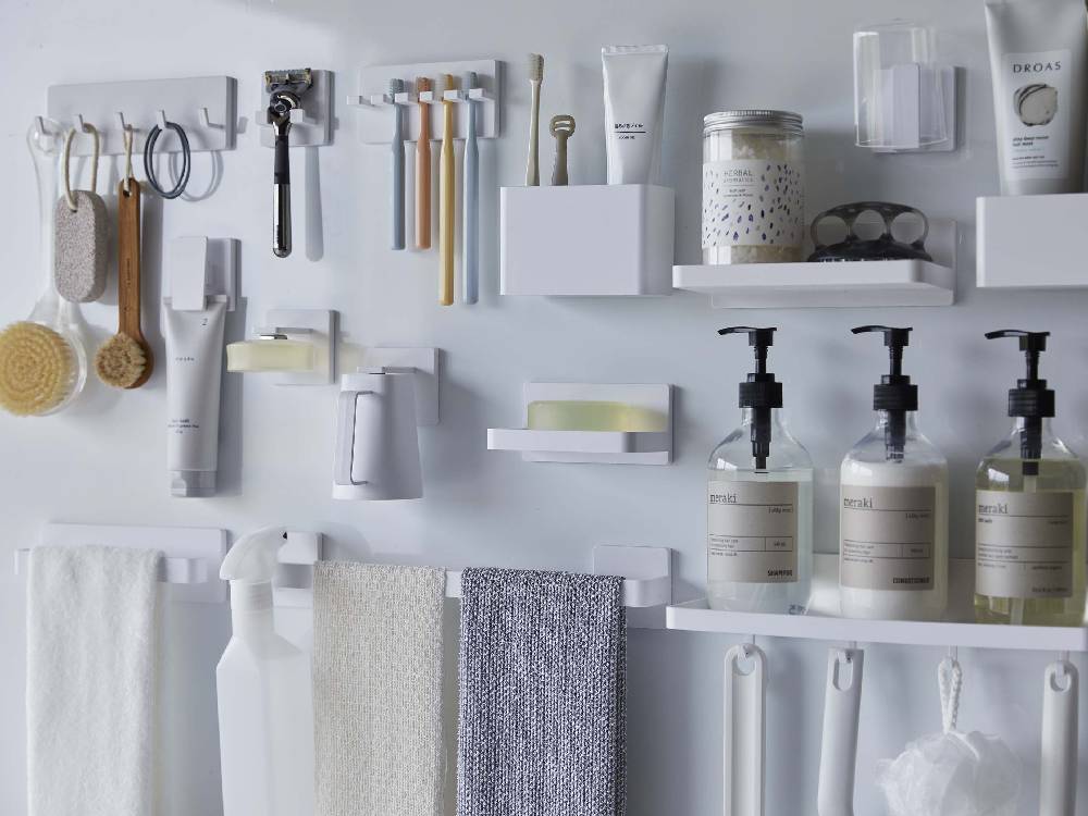 浴室に設置された【MIST/ミスト】フィルムフックラック W18。ブラシやタオルを収納する棚付きキャビネットが見えています。