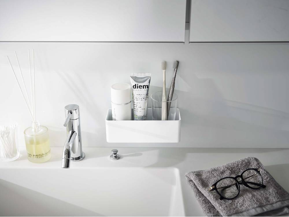 浴室のシンク横に【MIST/ミスト】フィルムフックラック W18が取り付けられ、ボトルや日用品が掛けられている様子