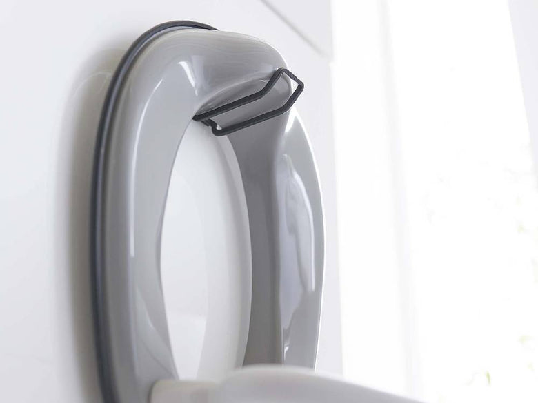 シルバー仕上げの【tower/タワー】フィルムフックトイレ用品収納フックがバスルームの壁に取り付けられている様子