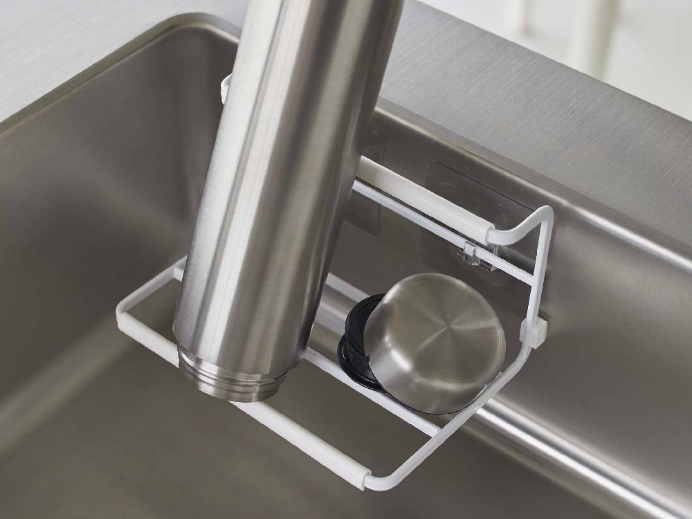 キッチンのシンクに取り付けられたタワー型フィルムフックワイドジャグボトルホルダー。金属製のフックに複数のボトルが掛かっている様子