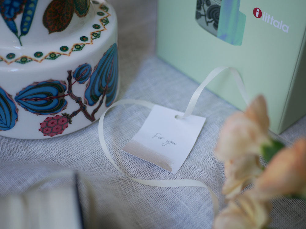 イッタラ製タイカサトベースにデコレーションされた磁器のケーキとカップ