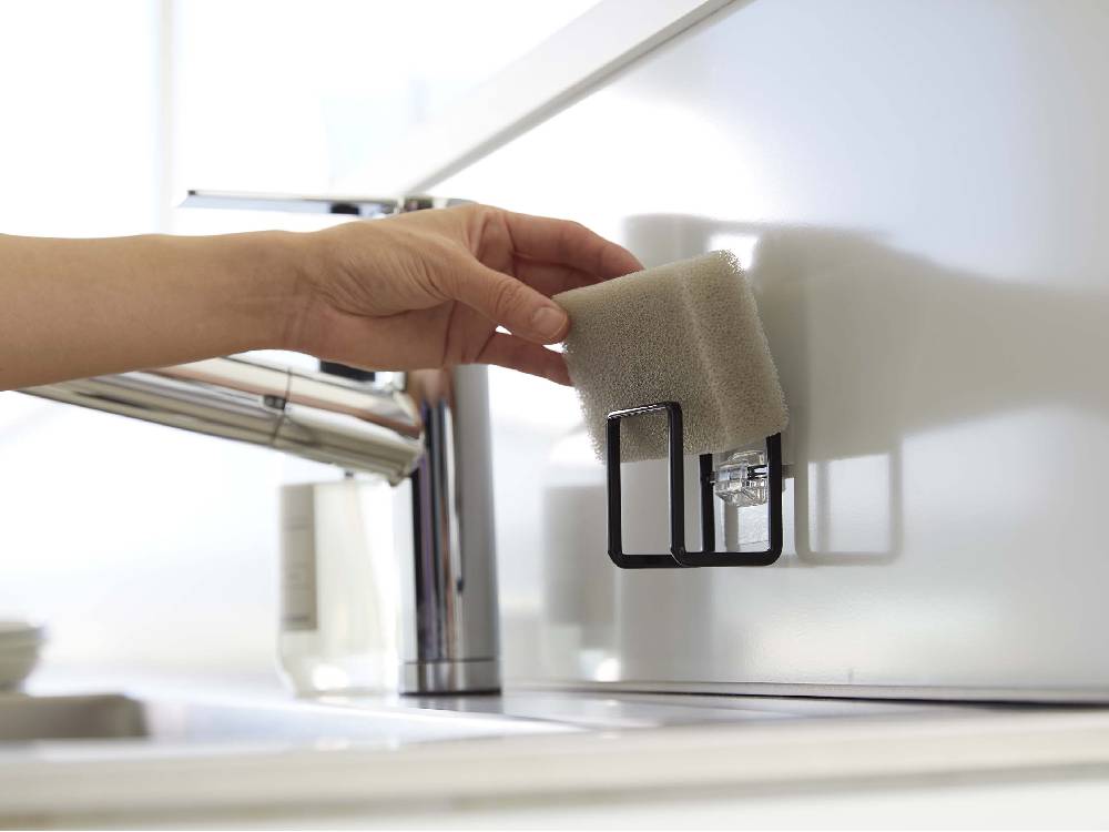 キッチンカウンターに設置されたタワー型フィルムフックスポンジホルダーと蛇口が配置されたシンクの様子