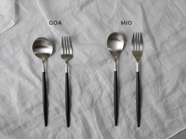 クチポールのMIOブラックシルバーカトラリー4本セットがテーブル上に美しく並べられている様子