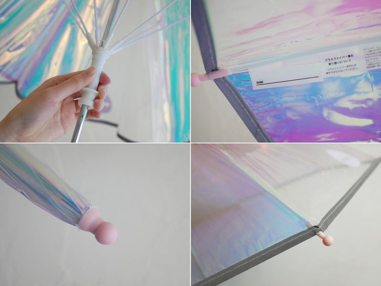 シャイニーピンクの子供用手開きプラスチック製傘。透明感があり風に揺れるデザイン。