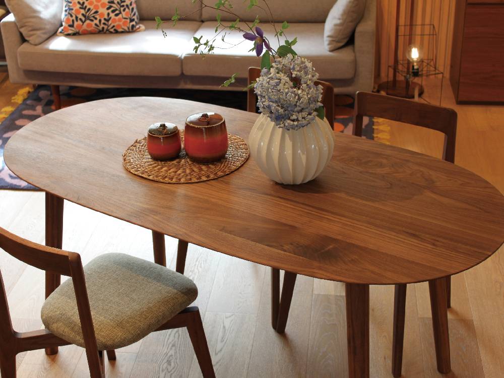 高野木工のRUBEシリーズダイニングテーブル。ホワイトオークまたはウォルナット無垢材を使用した木製テーブルで、室内のダイニングスペースに配置されています。