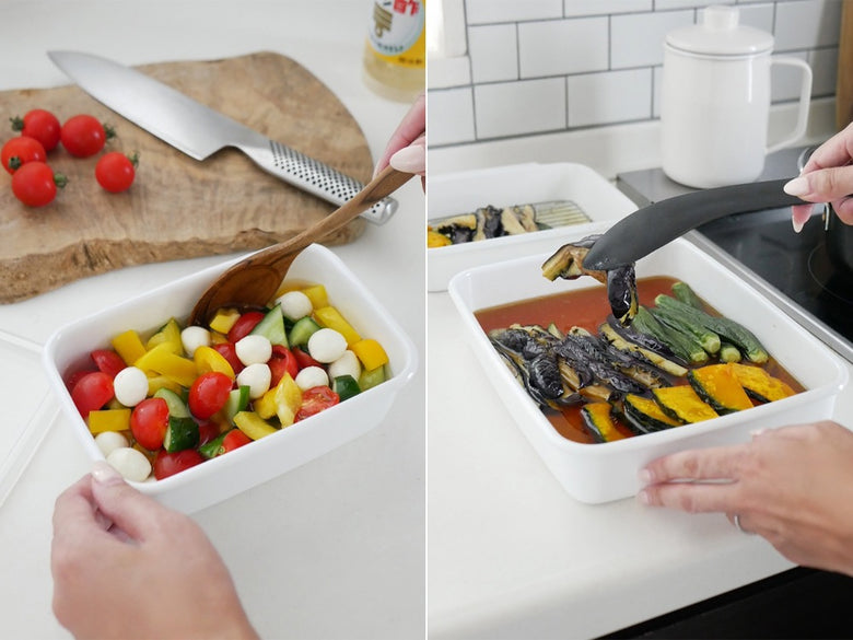 野田琺瑯ホワイトシリーズのシール蓋付きホーロー保存容器がキッチンに食材とともに並べられています