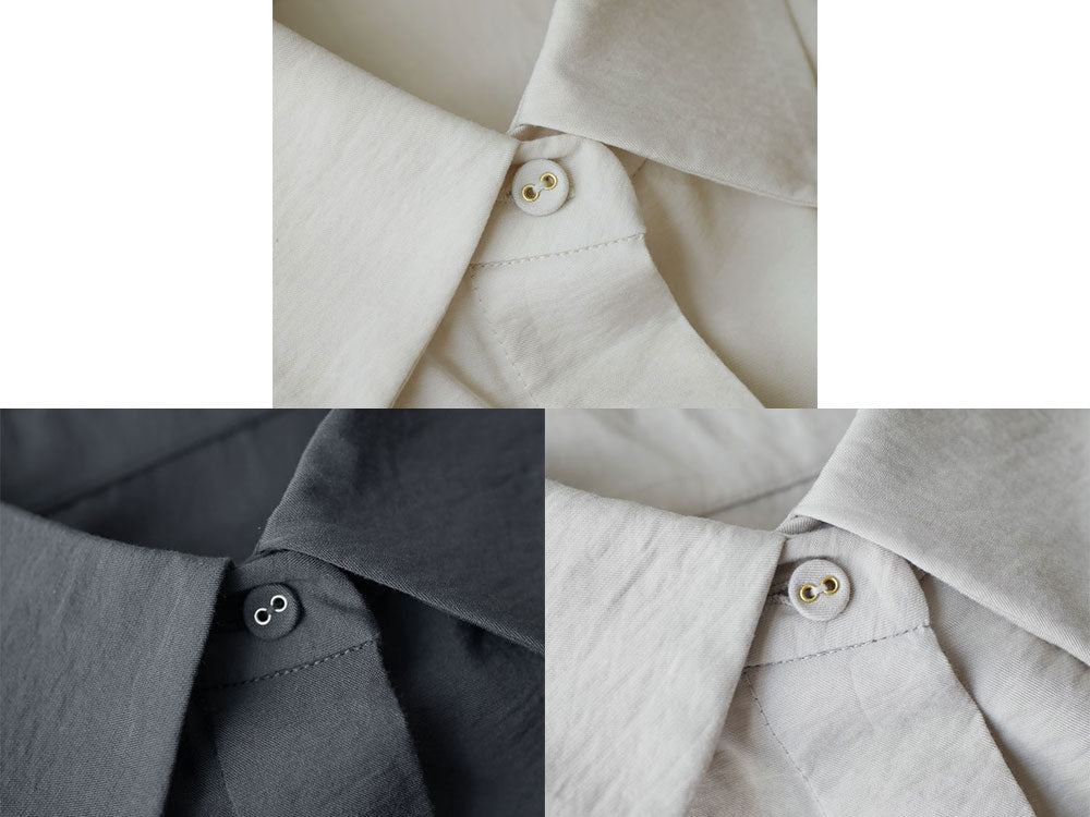オフホワイトまたはチャコールグレーの大人カジュアルシャツの前面画像。襟元にボタンが並び、袖やテキスタイルのディテールが際立つデザイン。