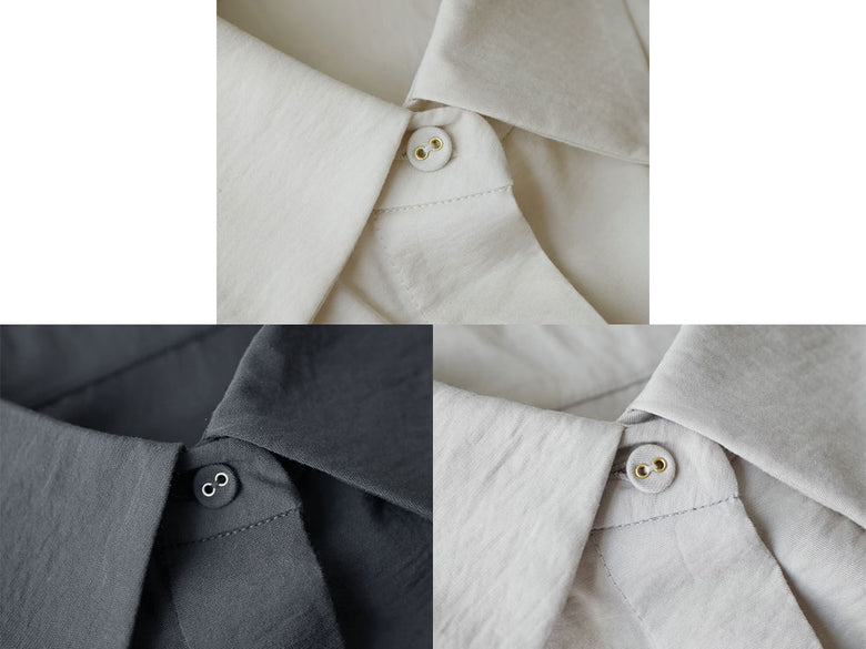 オフホワイトまたはチャコールグレーの大人カジュアルシャツの前面画像。襟元にボタンが並び、袖やテキスタイルのディテールが際立つデザイン。