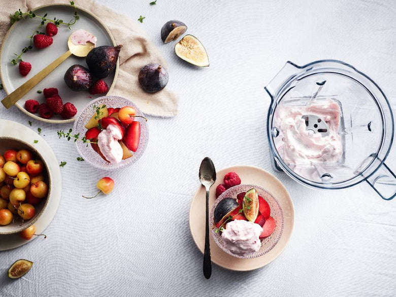 果物やベリーが盛られたボウルと食器、キッチン用具がテーブルに配置されている様子