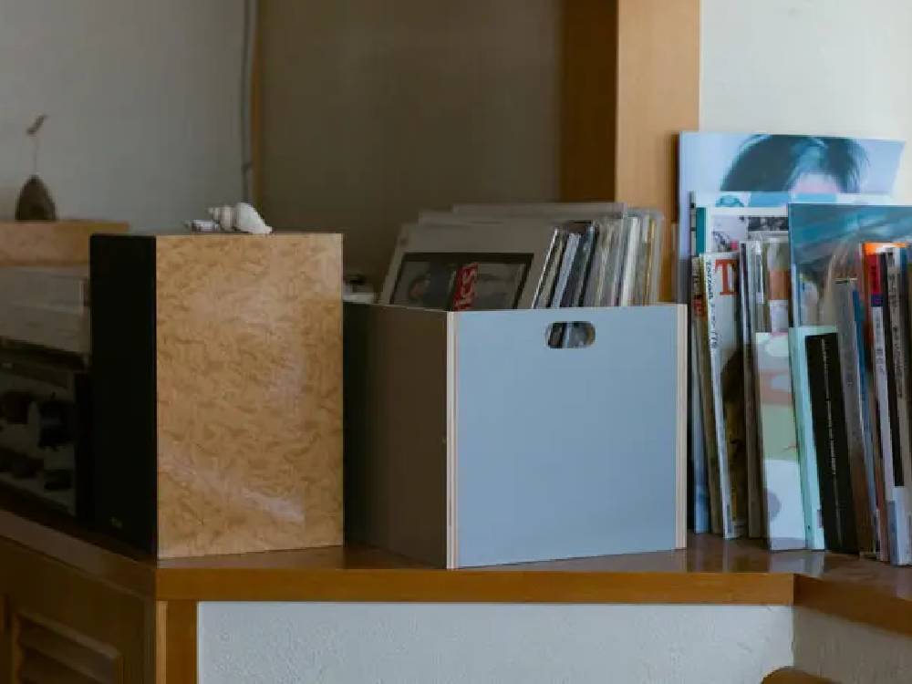 木製の棚に【MOHEIM/モヘイム】収納リンデンボックスが整然と並び、本やオフィス用品が整理されているインテリア風景