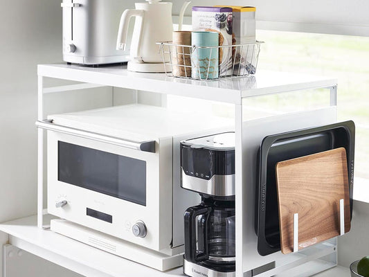 タワー型スチールパネル付きレンジラック。キッチンに設置され、複数の棚で調理器具や小型家電を収納できるデザイン。