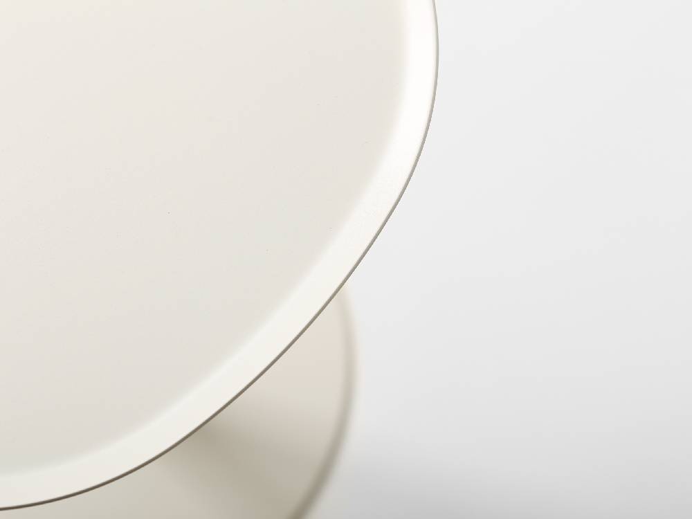 イデアコ スチールファニュチャー サイドテーブル23の上に、デザイン性の高い円形の磁器皿とソーサーが配置されたコーヒーテーブル